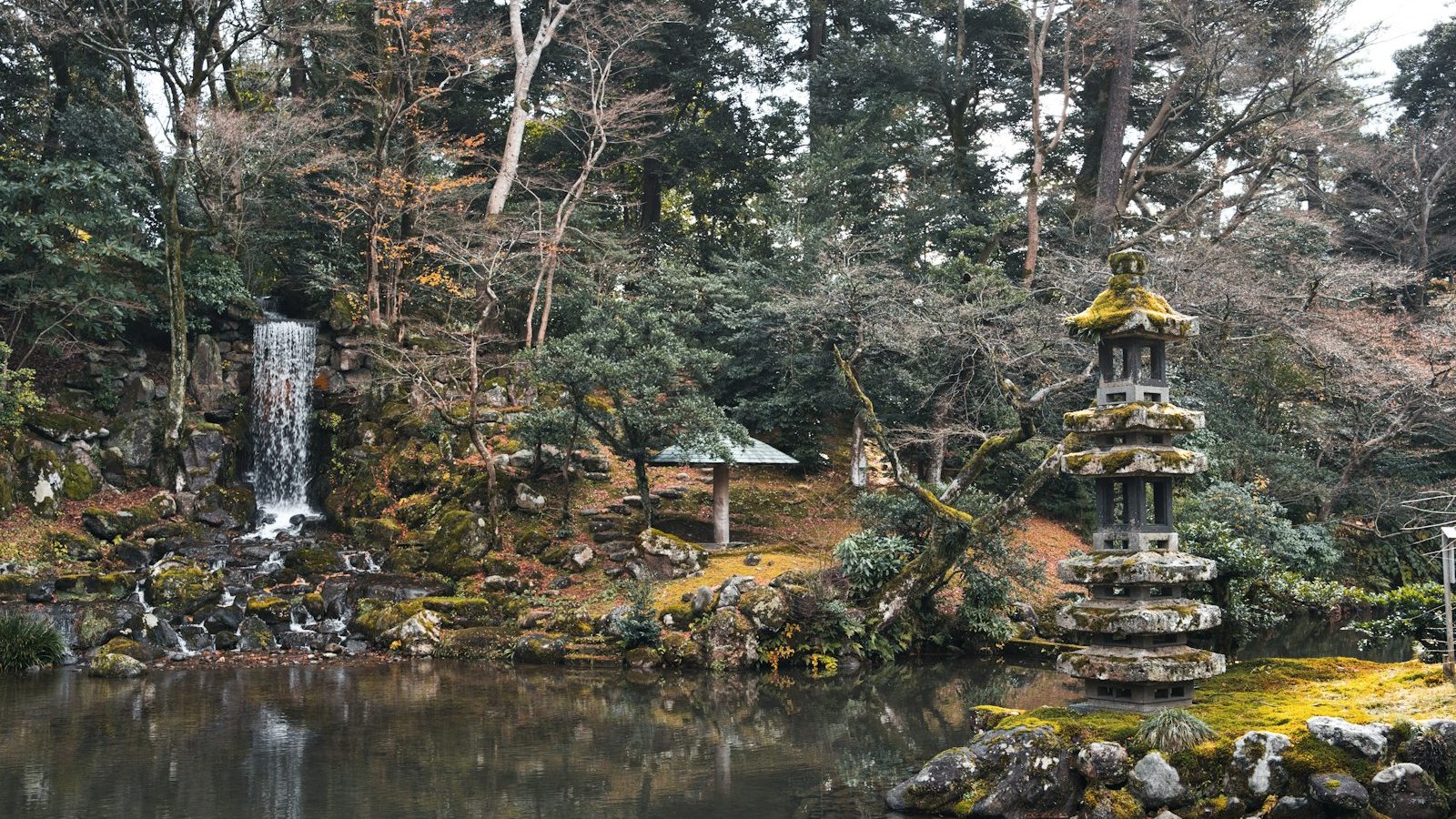 Garden pond with a small waterfall and a stone lantern