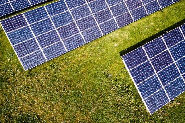 Solar panels mounted on grass in sunlight